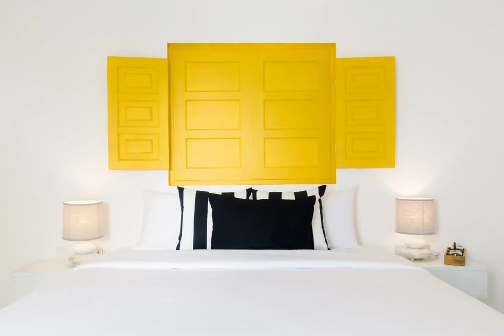 Two matching nightstands with identical lamps creating symmetry